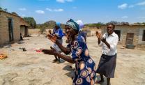 Janet Zirugo (in African attire) is in one of her joyful moments doing what she enjoys most- singing and dancing to lift up her spirits.