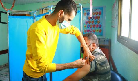 Health worker Mosab Khbees administers a vaccine in Al Moghraga, Gaza, in November 2021. Al Moghraga is a remote vulnerable area that has very little access to services. It is located in the south of Gaza City.