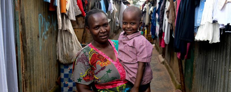 Grandmother holding her grandson in Nairobi city